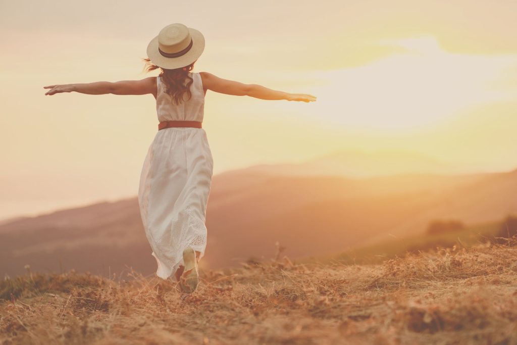 woman walking toward sunset