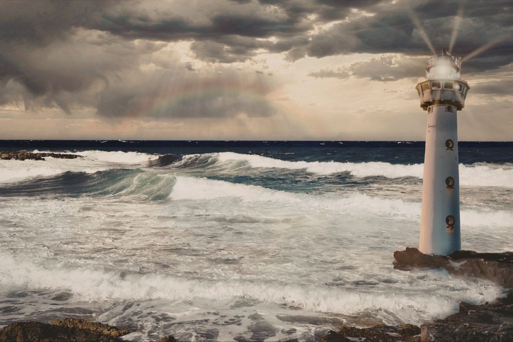A lighthouse in the ocean as a storm approaches